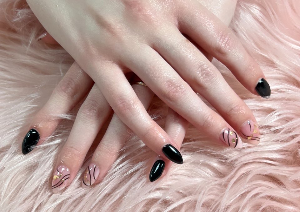 Nail technician shaping a fresh manicure.
